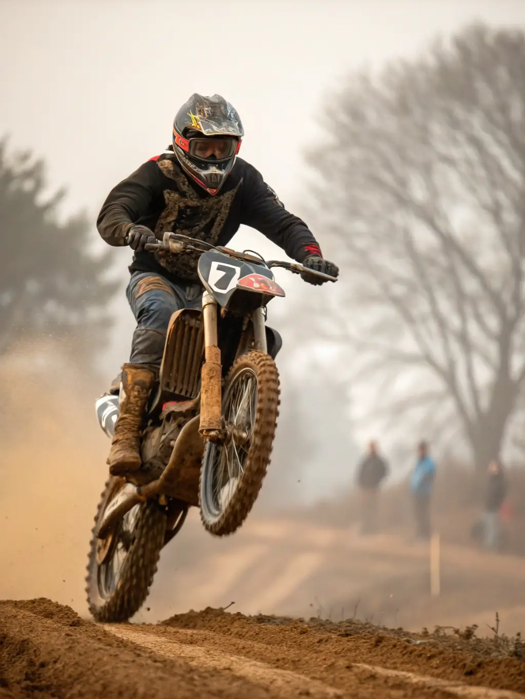 A young motocross rider in full gear, confidently navigating a dirt track during a training session organized by LES CAGOUILLES GUIDONNEES, showcasing skill development and safe riding practices.